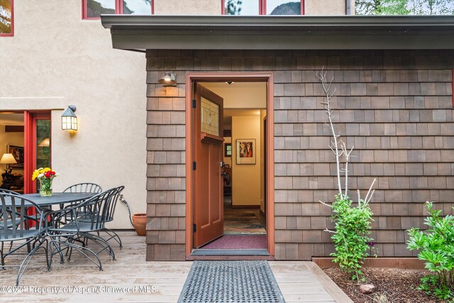 135 Irwin Dr, Redstone, CO 81623 - property entrance featuring outdoor dining area and stucco siding