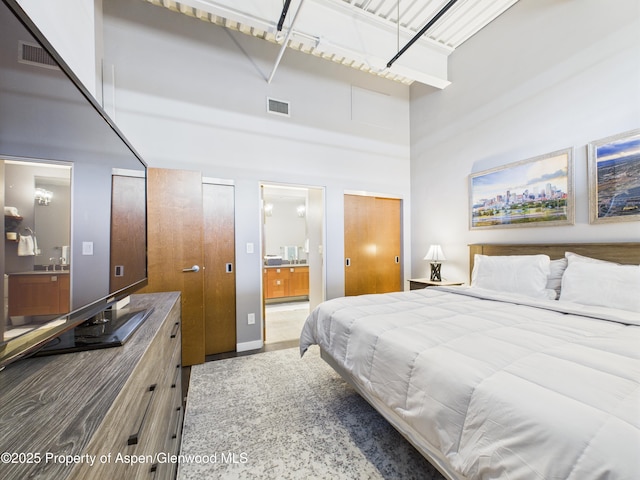 231 Robinson St Unit R306, Basalt, CO 81621 - bedroom featuring a high ceiling, ensuite bathroom, and two closets