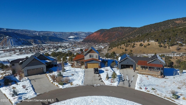 snowy aerial view featuring a mountain view