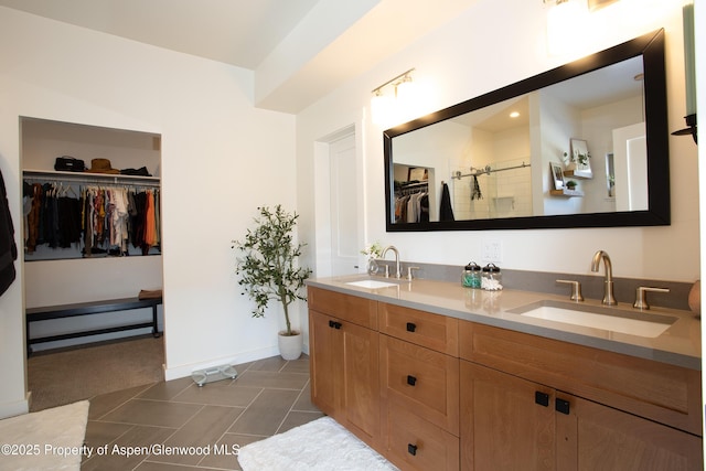 bathroom with tile patterned flooring, a shower, and vanity