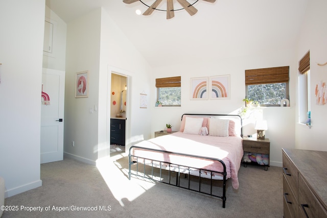 carpeted bedroom with high vaulted ceiling, ceiling fan, and connected bathroom