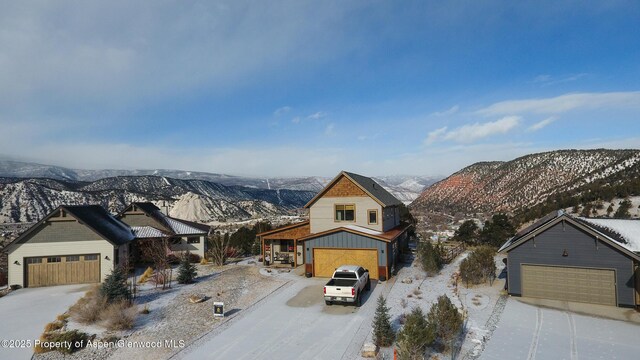 snowy aerial view with a mountain view