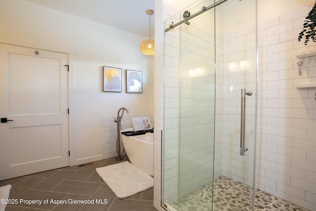 bathroom featuring tile patterned flooring and independent shower and bath