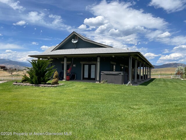 566 Latham Ranch Rd, Rifle, CO 81650 - rear view of property with a hot tub, a mountain view, french doors, and a shingled roof