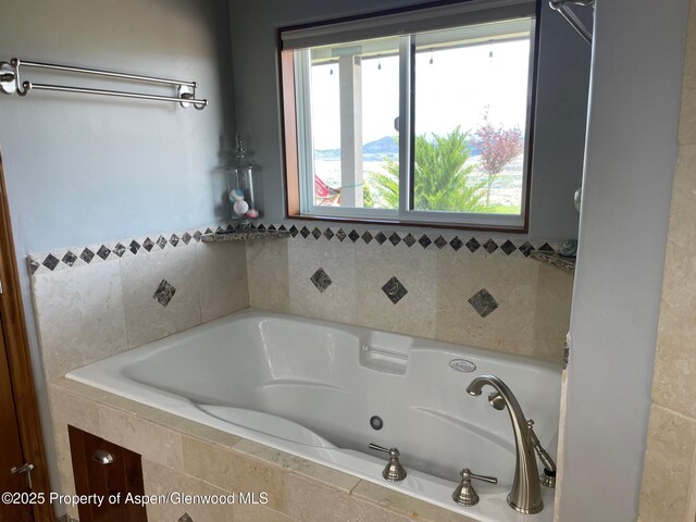 566 Latham Ranch Rd, Rifle, CO 81650 - full bath with a relaxing tiled tub and plenty of natural light