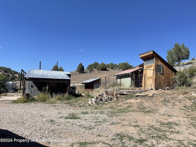 view of home's exterior with an outbuilding