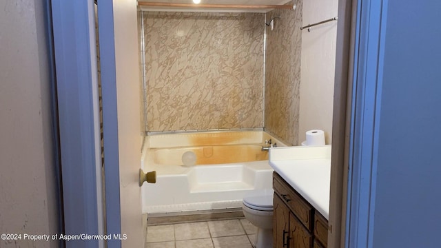 bathroom with tile patterned flooring, vanity, toilet, and a tub