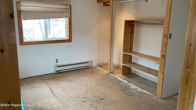 unfurnished bedroom featuring a baseboard radiator and a closet