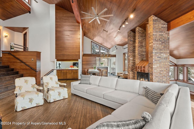 living room with high vaulted ceiling and wood ceiling