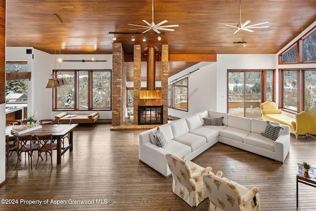 living room featuring a fireplace, dark wood-type flooring, ceiling fan, and wooden ceiling