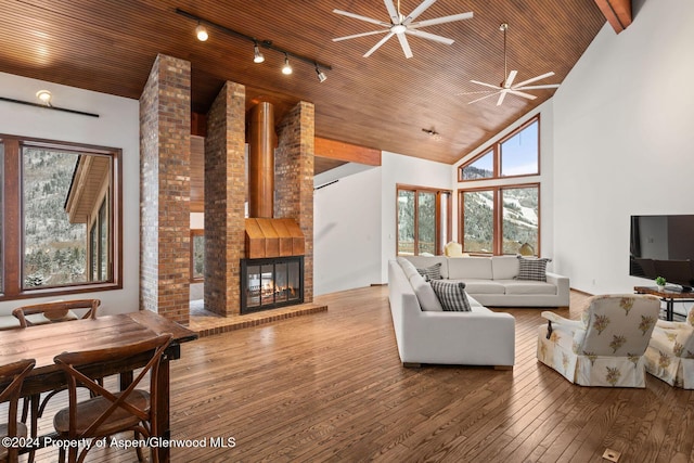 living room featuring ceiling fan, a large fireplace, wooden ceiling, high vaulted ceiling, and hardwood / wood-style floors