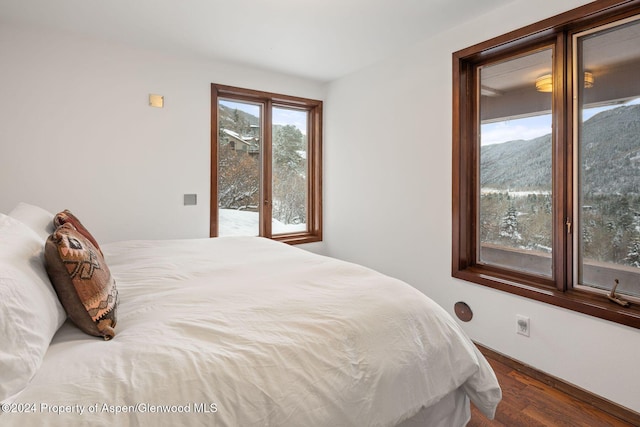 bedroom featuring a mountain view and hardwood / wood-style floors