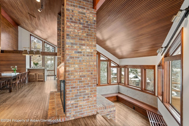 unfurnished sunroom with lofted ceiling, plenty of natural light, and wooden ceiling