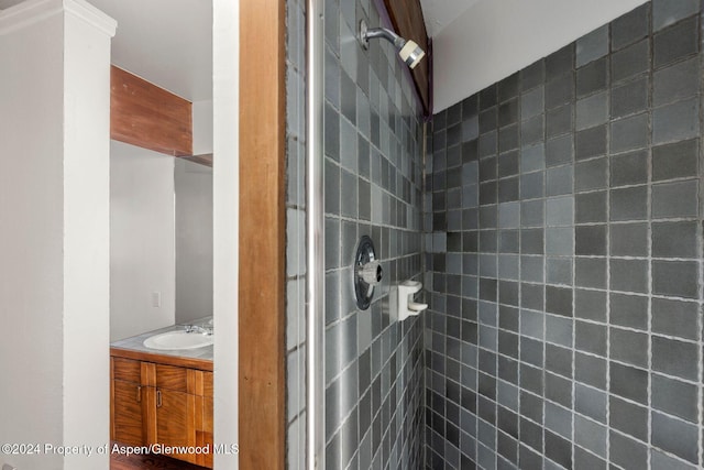 bathroom with vanity and tiled shower