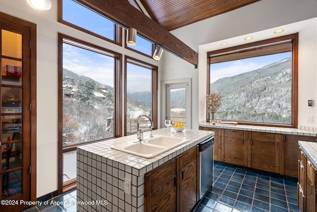 kitchen featuring a mountain view, a center island, dishwasher, and sink