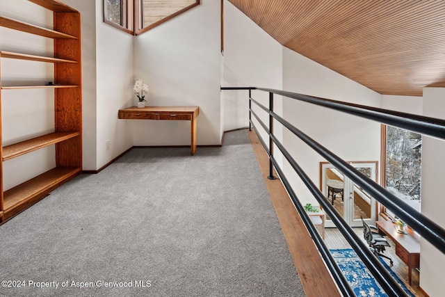 corridor featuring wood ceiling and light carpet