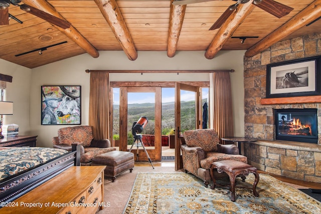 interior space with vaulted ceiling with beams, wood ceiling, a fireplace, and french doors