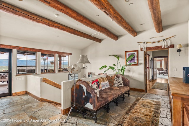 living room with vaulted ceiling with beams