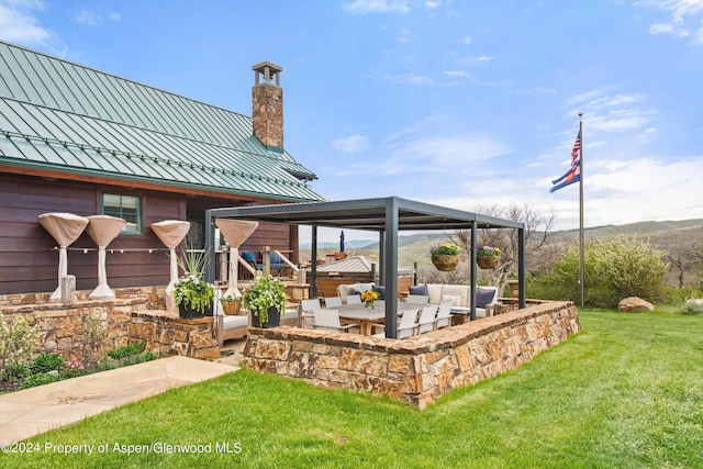 view of patio / terrace featuring an outdoor living space and a mountain view