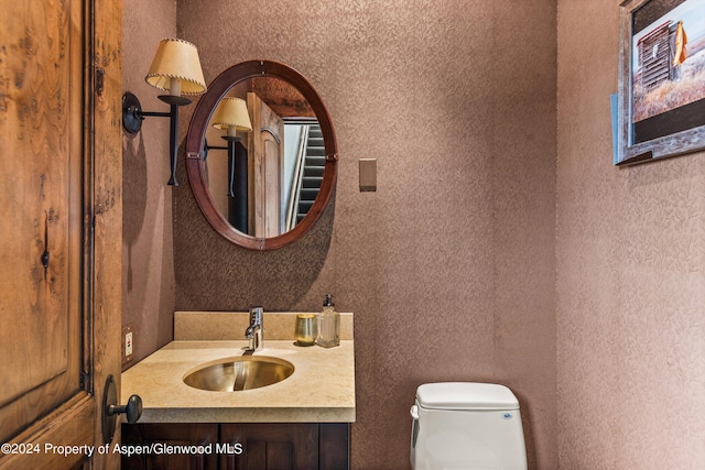 bathroom with vanity and toilet