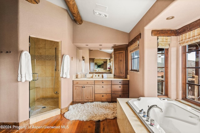 bathroom with shower with separate bathtub, vanity, lofted ceiling with beams, and hardwood / wood-style floors