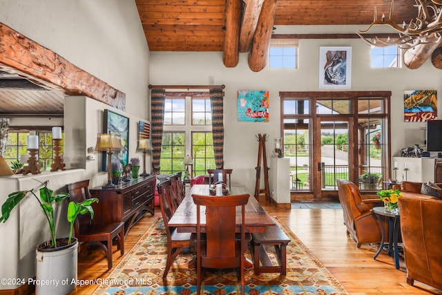 dining area with beamed ceiling, french doors, wooden ceiling, and a high ceiling