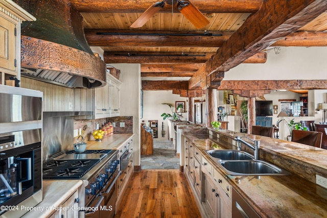 kitchen featuring beam ceiling, sink, wooden ceiling, high end stove, and custom range hood