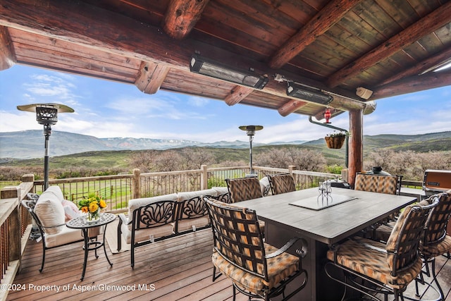 wooden terrace with a mountain view and an outdoor hangout area