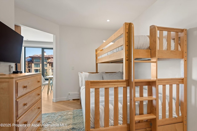 bedroom featuring baseboard heating and light wood-type flooring