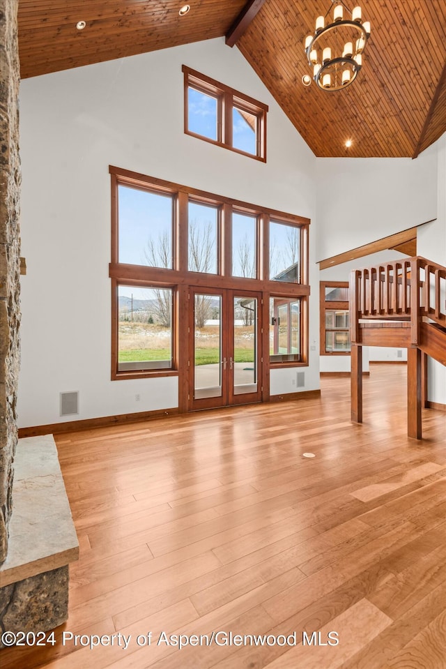 199 Bluestem Ct, Carbondale, CO 81623 - unfurnished living room with beam ceiling, high vaulted ceiling, a chandelier, light hardwood / wood-style floors, and wood ceiling