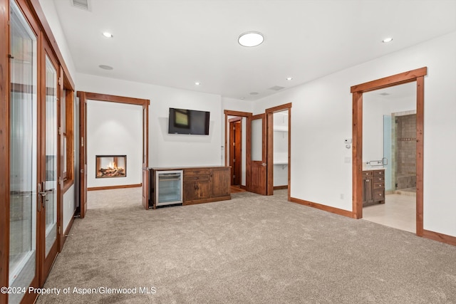 199 Bluestem Ct, Carbondale, CO 81623 - unfurnished bedroom with wine cooler, light carpet, connected bathroom, and french doors