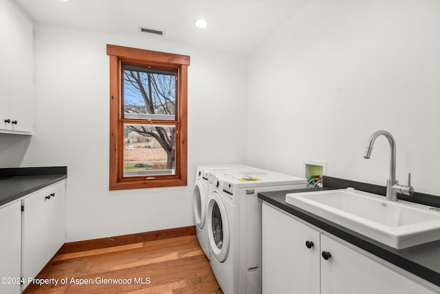 199 Bluestem Ct, Carbondale, CO 81623 - laundry room with washer and dryer, sink, cabinets, and light wood-type flooring