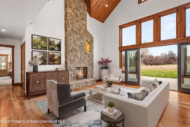 199 Bluestem Ct, Carbondale, CO 81623 - living room with a stone fireplace, high vaulted ceiling, wooden ceiling, and light wood-type flooring