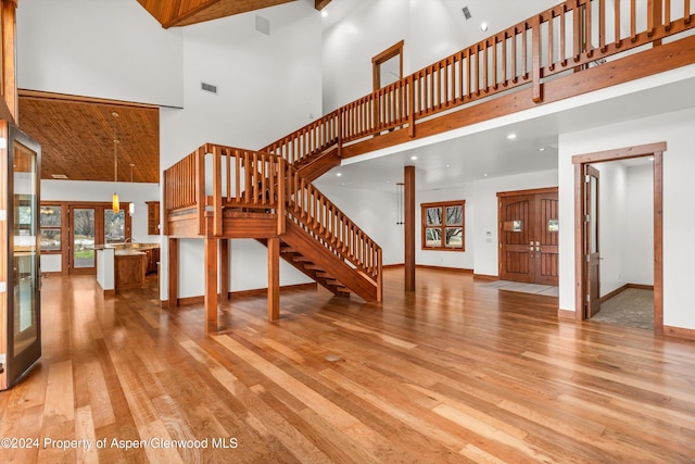 199 Bluestem Ct, Carbondale, CO 81623 - unfurnished living room with light hardwood / wood-style flooring, a high ceiling, and french doors