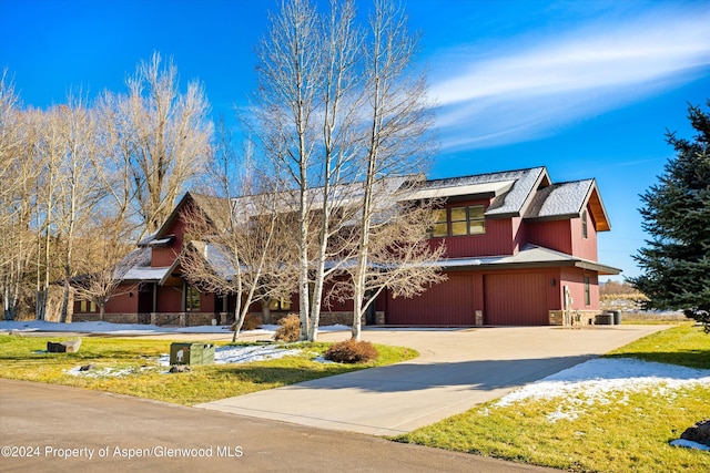 199 Bluestem Ct, Carbondale, CO 81623 - view of front facade featuring cooling unit, a garage, and a front yard