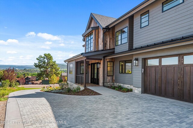 view of front facade with a mountain view and a garage