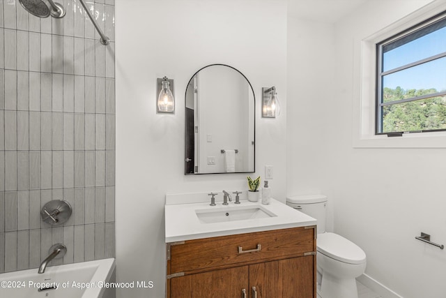 full bathroom with vanity, toilet, and tiled shower / bath combo