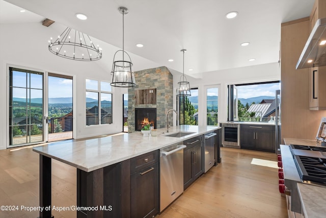 kitchen featuring stainless steel appliances, sink, a mountain view, hanging light fixtures, and a large island