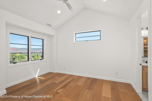 unfurnished room featuring ceiling fan, wood-type flooring, and lofted ceiling