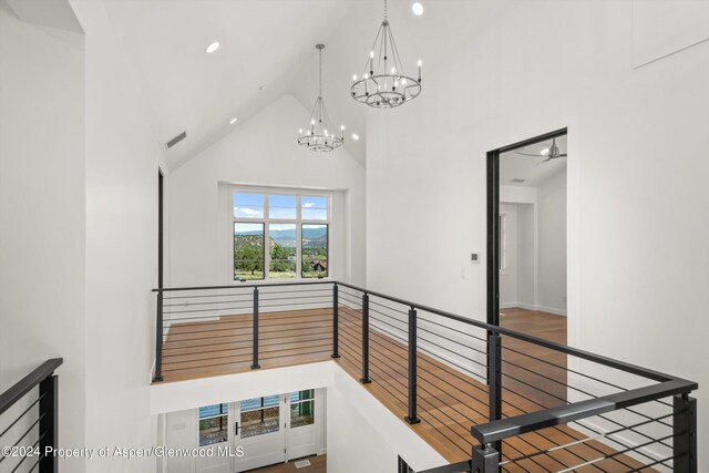 hall with high vaulted ceiling and an inviting chandelier