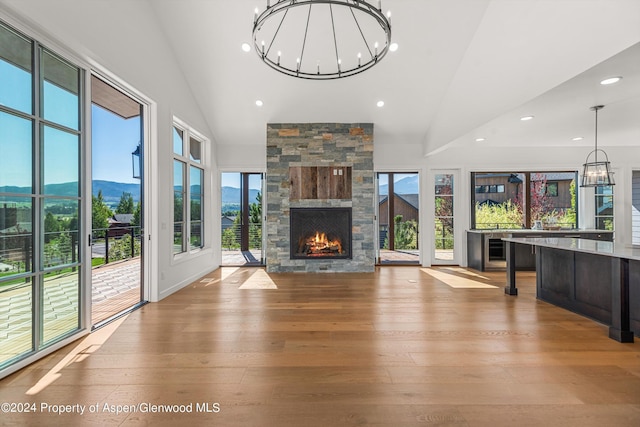 unfurnished living room featuring a mountain view, light hardwood / wood-style flooring, and plenty of natural light