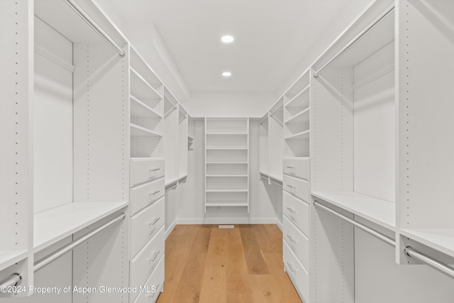 spacious closet featuring light hardwood / wood-style flooring