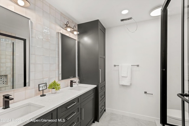 bathroom with vanity, a shower with door, backsplash, and tile walls