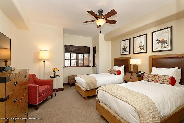 bedroom with light carpet and ceiling fan