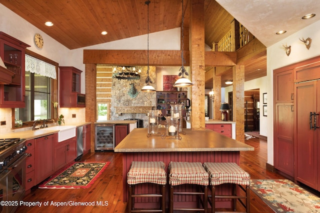 5548 Frying Pan Rd, Basalt, CO 81621 - kitchen with wine cooler, dark wood-style flooring, lofted ceiling, appliances with stainless steel finishes, and tasteful backsplash