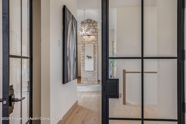 112 Bowles Dr, Carbondale, CO 81623 - hallway featuring a chandelier, wood finished floors, and baseboards