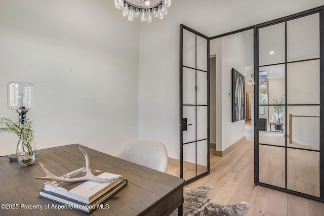112 Bowles Dr, Carbondale, CO 81623 - home office featuring light wood-style flooring and a chandelier