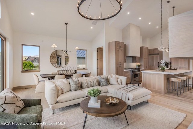 112 Bowles Dr, Carbondale, CO 81623 - living room featuring a chandelier, high vaulted ceiling, light wood-style flooring, and recessed lighting