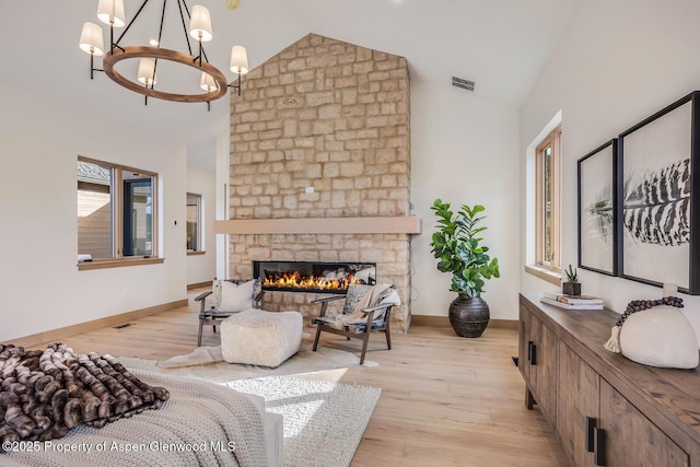 112 Bowles Dr, Carbondale, CO 81623 - living area with a chandelier, light wood finished floors, a fireplace, high vaulted ceiling, and baseboards