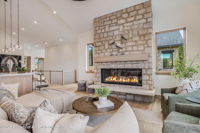 112 Bowles Dr, Carbondale, CO 81623 - living area with wood finished floors, a stone fireplace, recessed lighting, and high vaulted ceiling